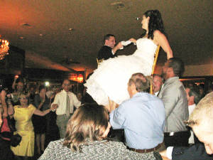 Wedding hora bride and groom lifted in chairs.jpg