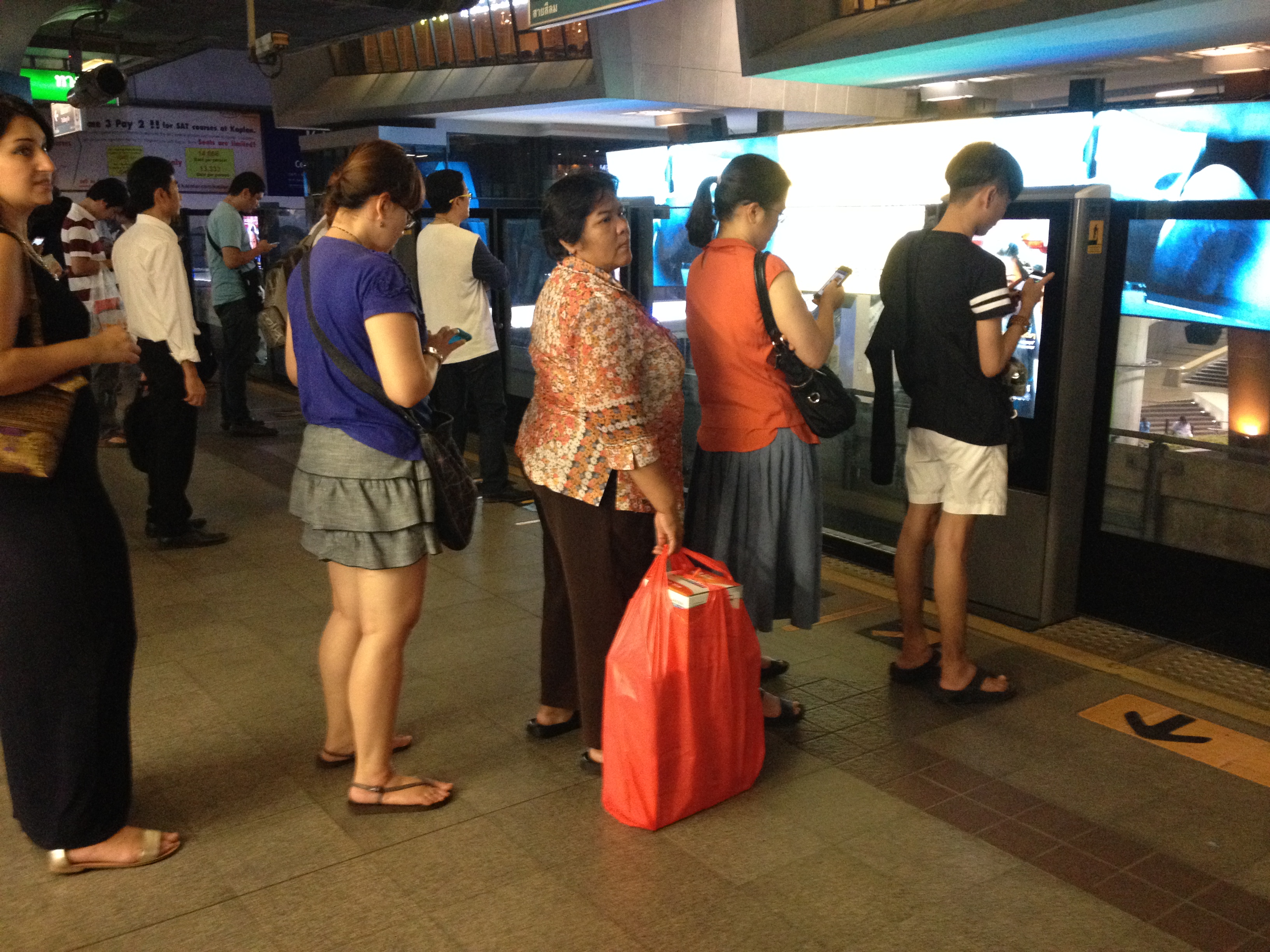 Lining up for Skytrain in Bangkok.JPG